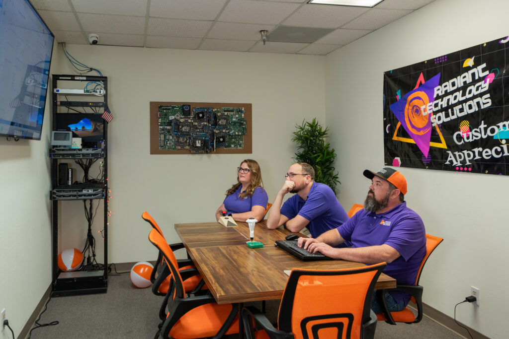 Radiant Technology Solutions IT support team monitoring network infrastructure and reviewing technology systems in Tarpon Springs Florida.